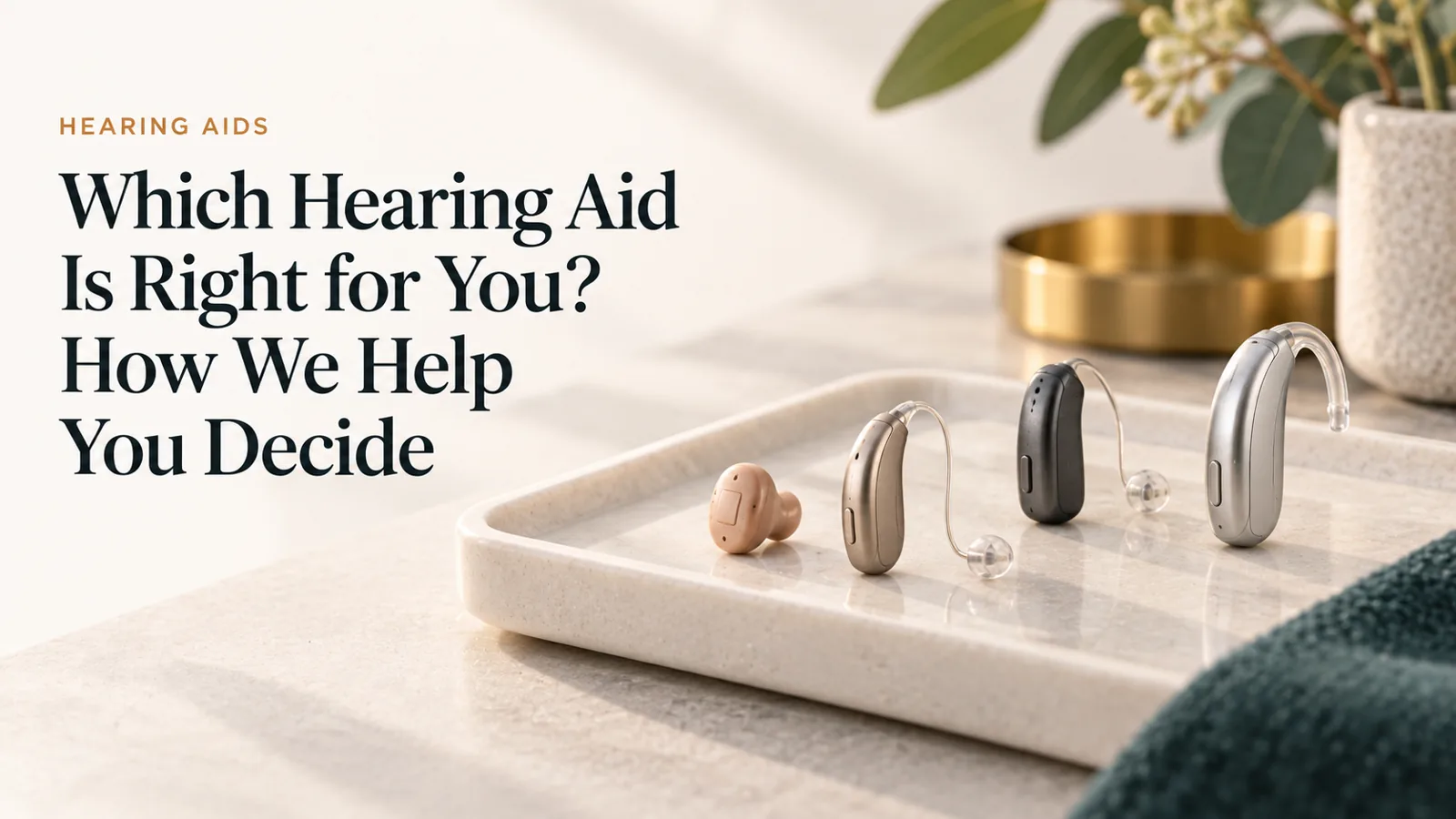 A small, tasteful selection of modern hearing aids arranged on a pale tray.